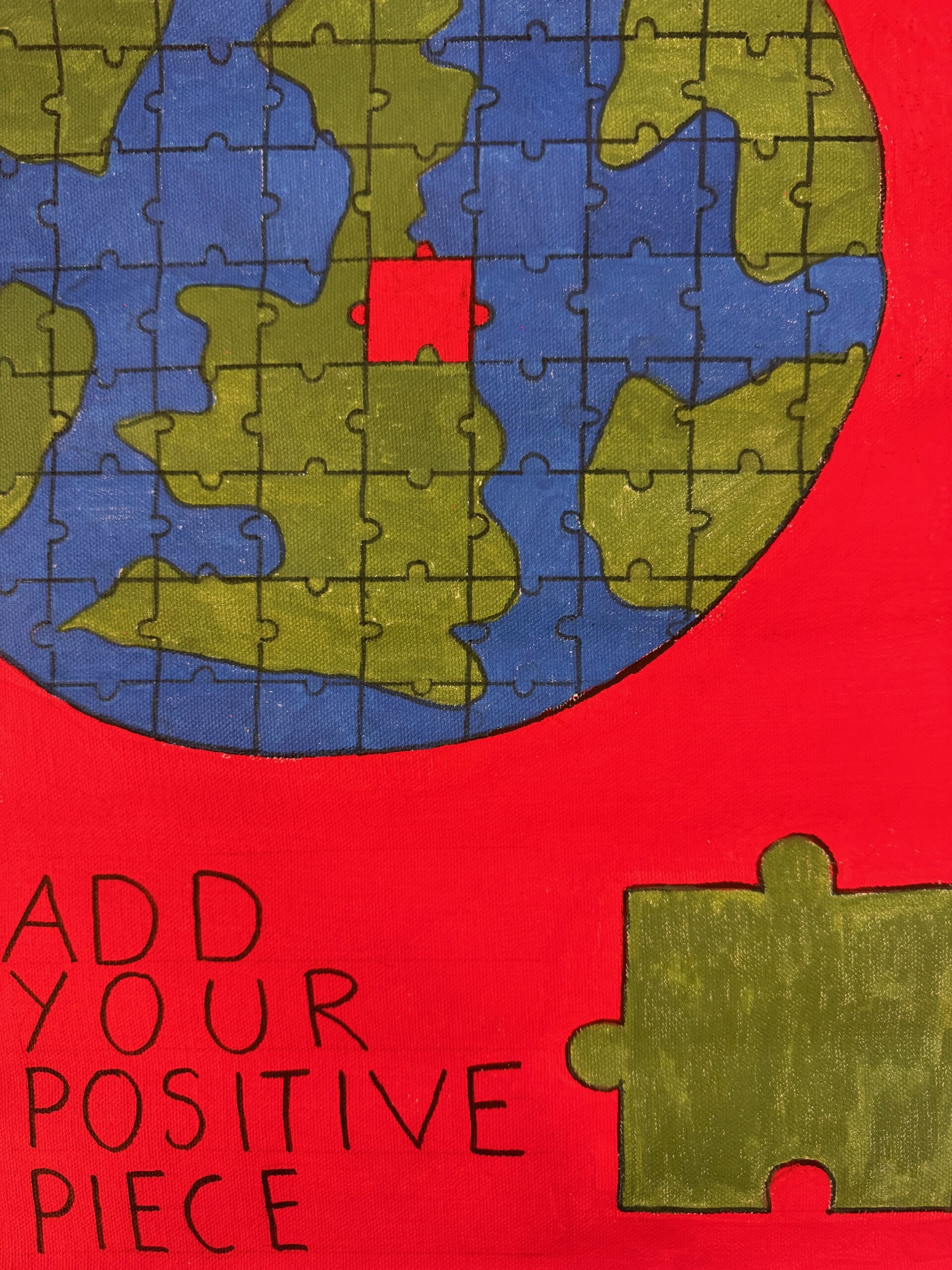 A painting of a globe, that is pieced together like a jigsaw. One piece is missing, found to the bottom right of the image. On the left, text reads "Add your positive piece"